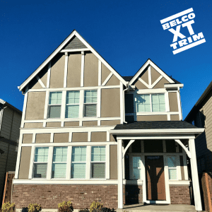 Two story beige home with white exterior window trim