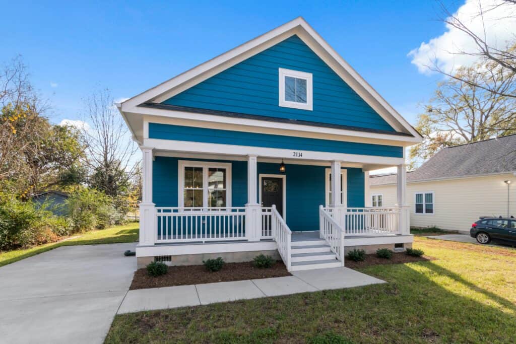 A newly finished family home with bright blue siding and white wood trim.